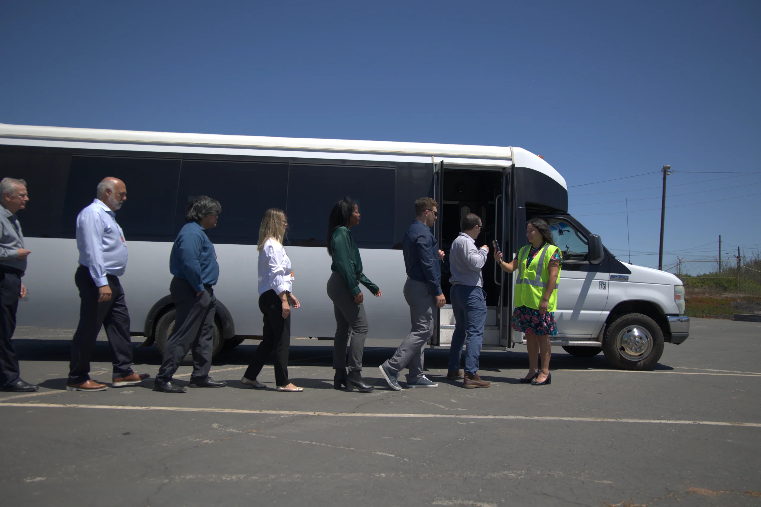 workers boarding a shuttle bus
